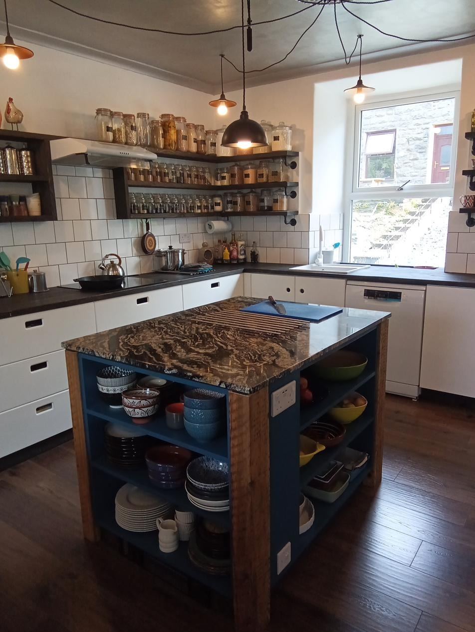 Custom island with one off granite worktop on salvaged wood legs